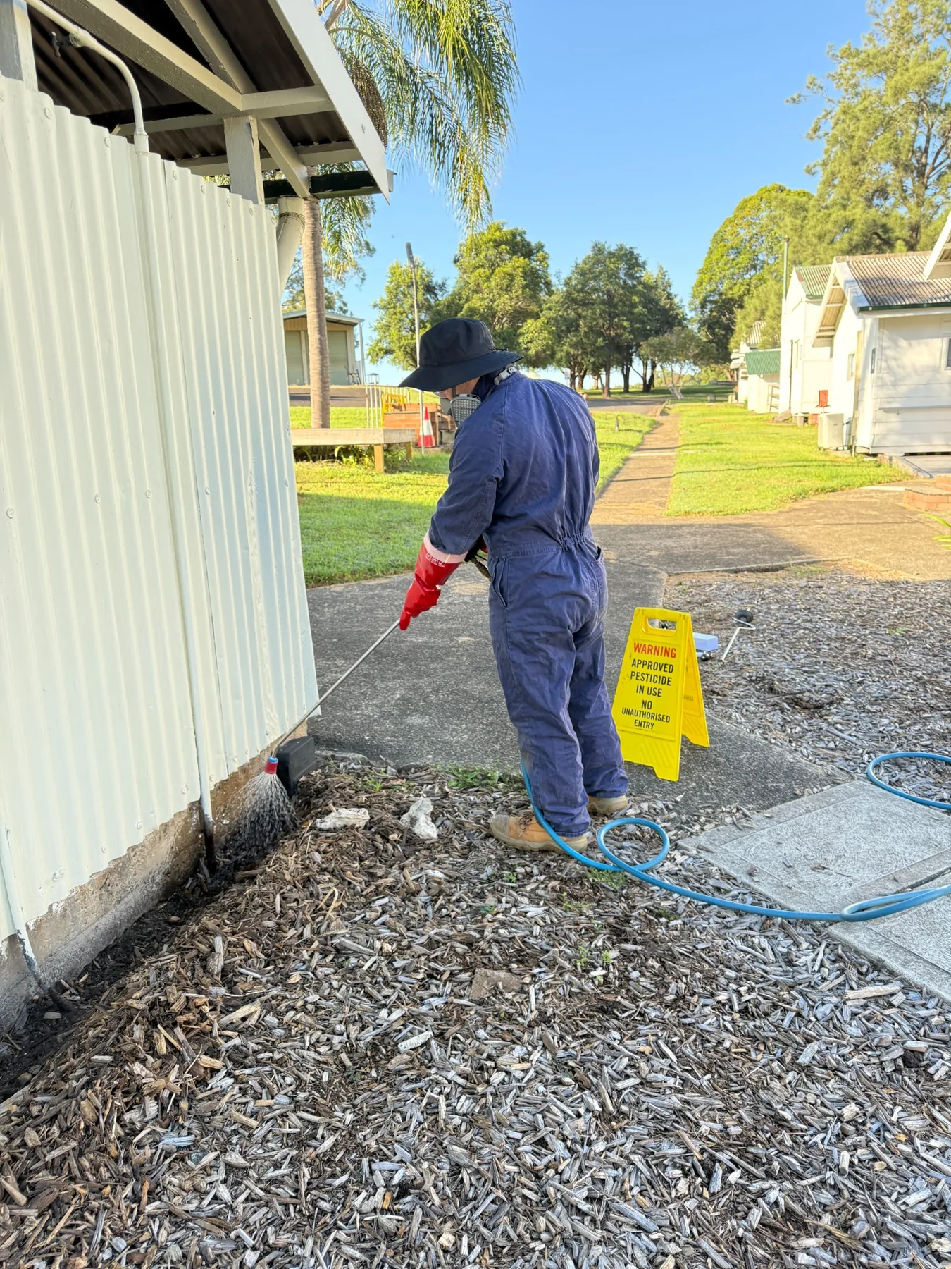 Goliath Pest Solutions technician carrying out termite treatment at a Sydney property